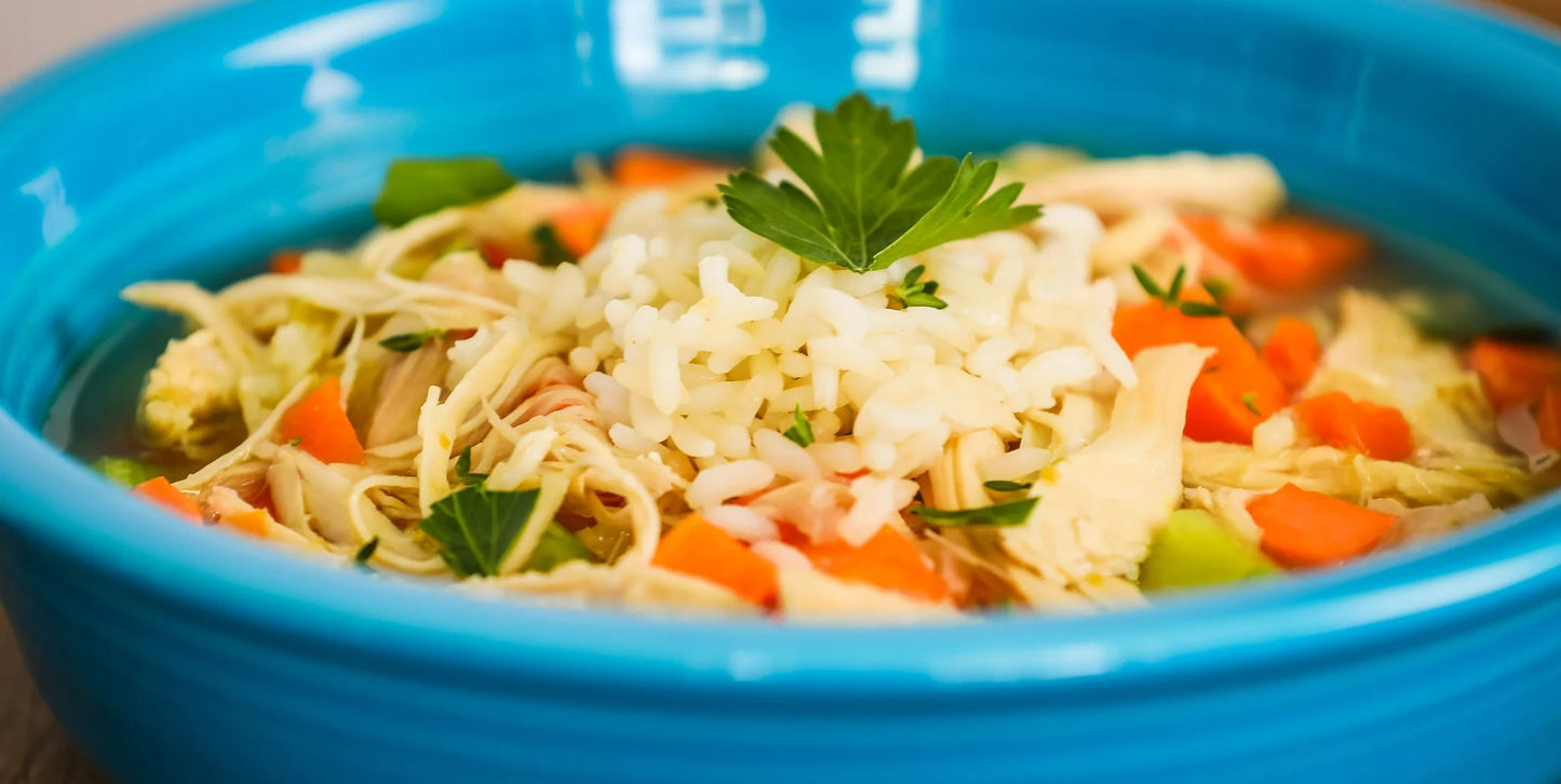 Chicken and Rice soup with vegetables in a blue bowl