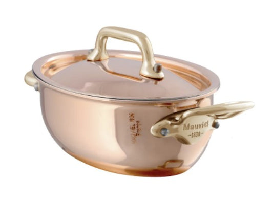 A copper-colored 0.42 QT oval stewpan with a lid and two handles, branded with 'mauviel' on the front.