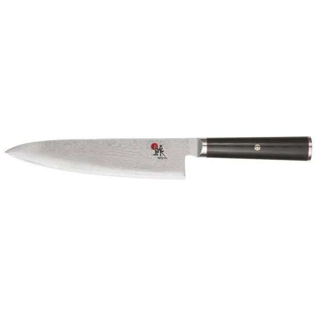 A Miyabi Kaizen 8-inch chef's knife with a Damascus patterned blade and a black linen Micarta handle.