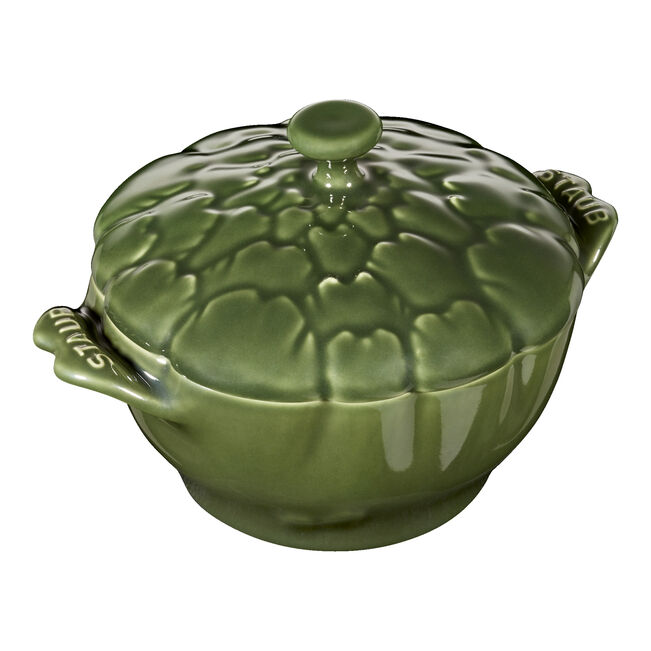 Green ceramic casserole dish with lid on a white background